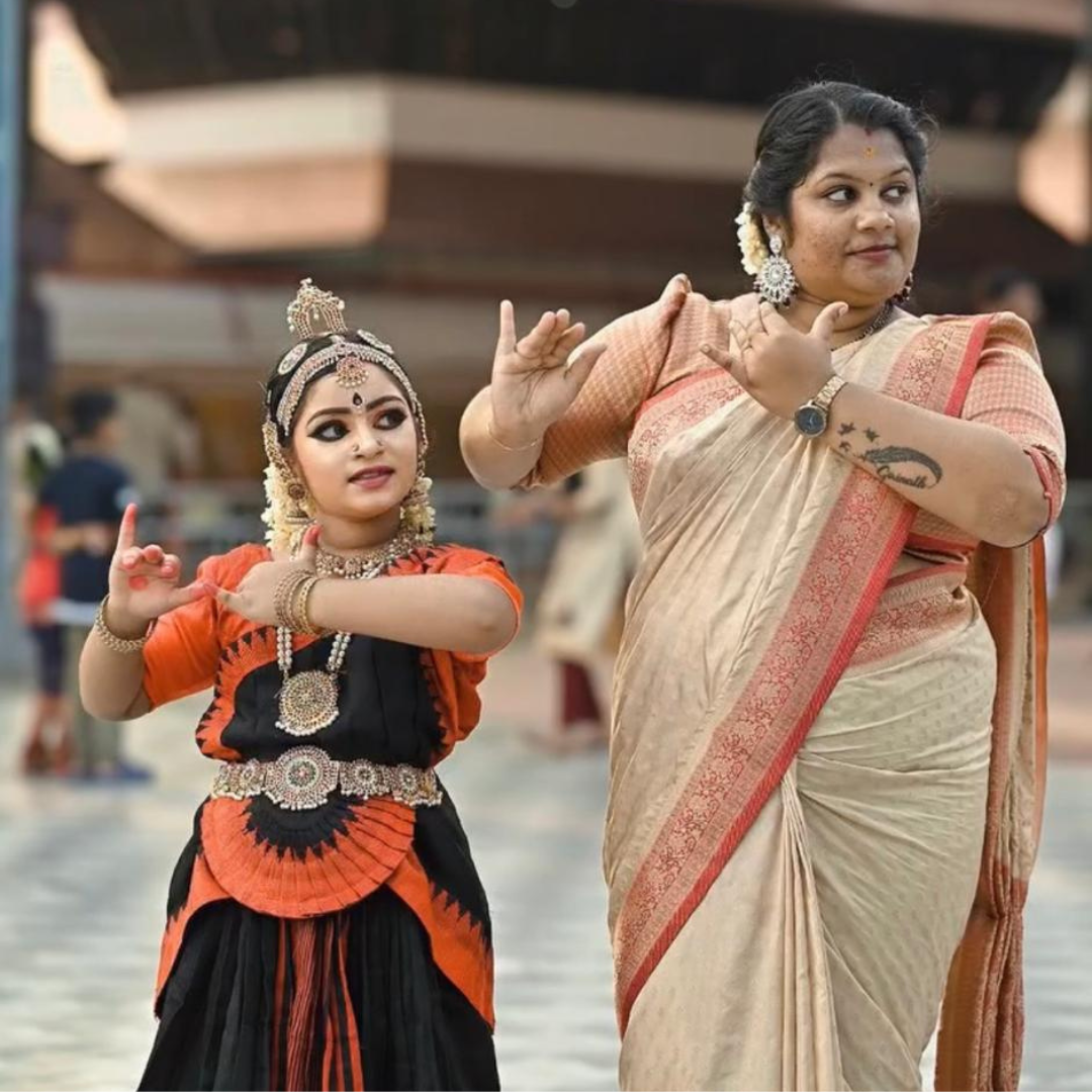 1. A woman in traditional Indian attire gracefully holds a vibrant flower, showcasing cultural elegance and beauty.<br />